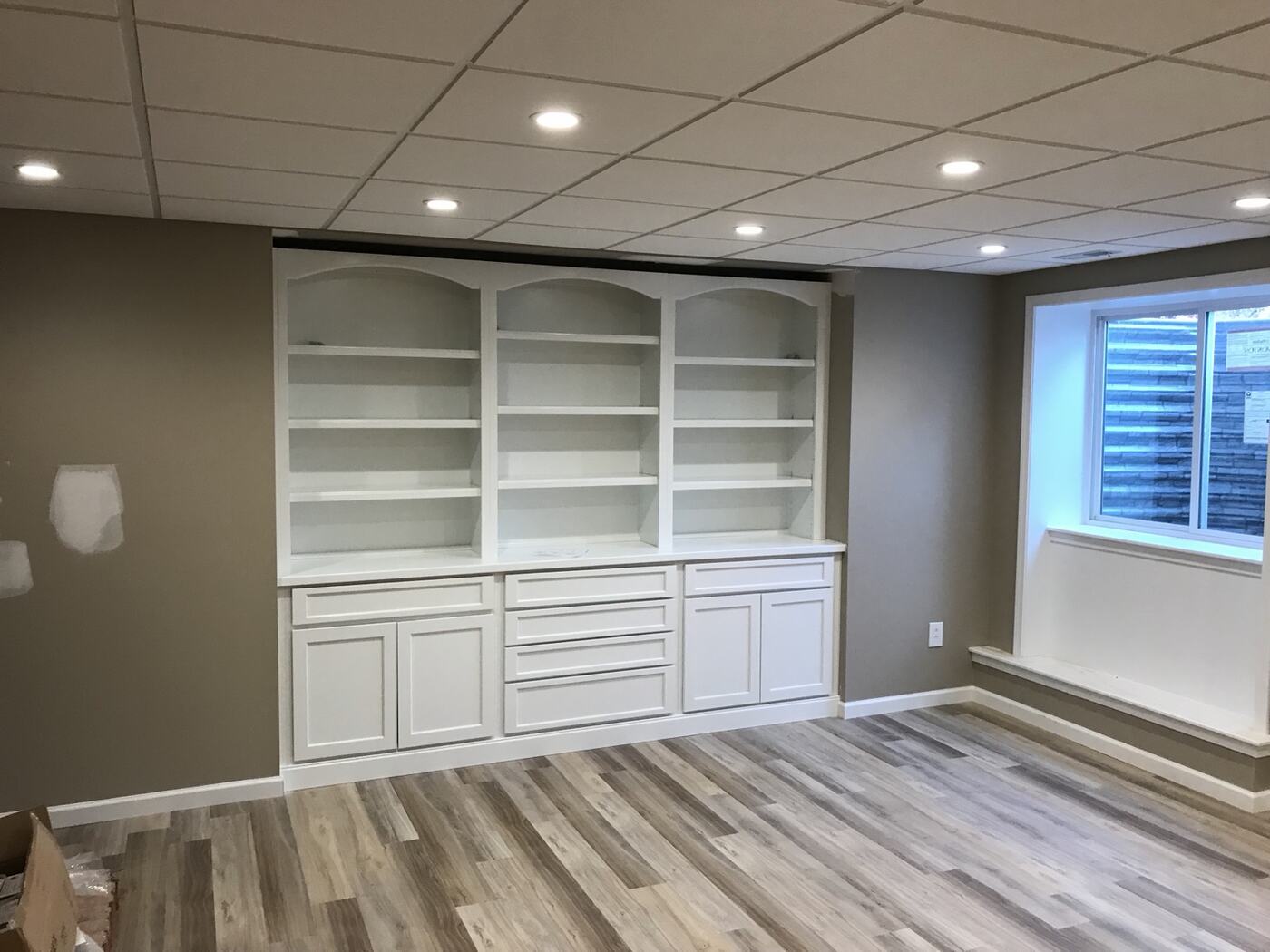 Finished basement with custom built-in shelving